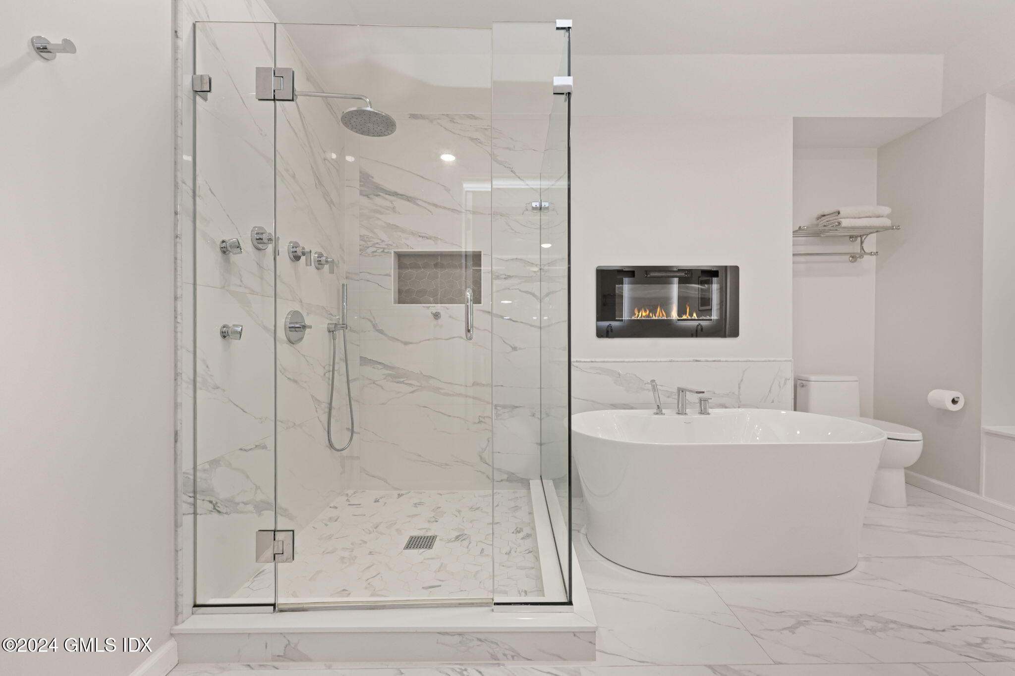 48 Spring Street, Unit 8 Greenwich, CT 06830 - Photo 18 of 24 a bathroom with a shower a mirror and a sink