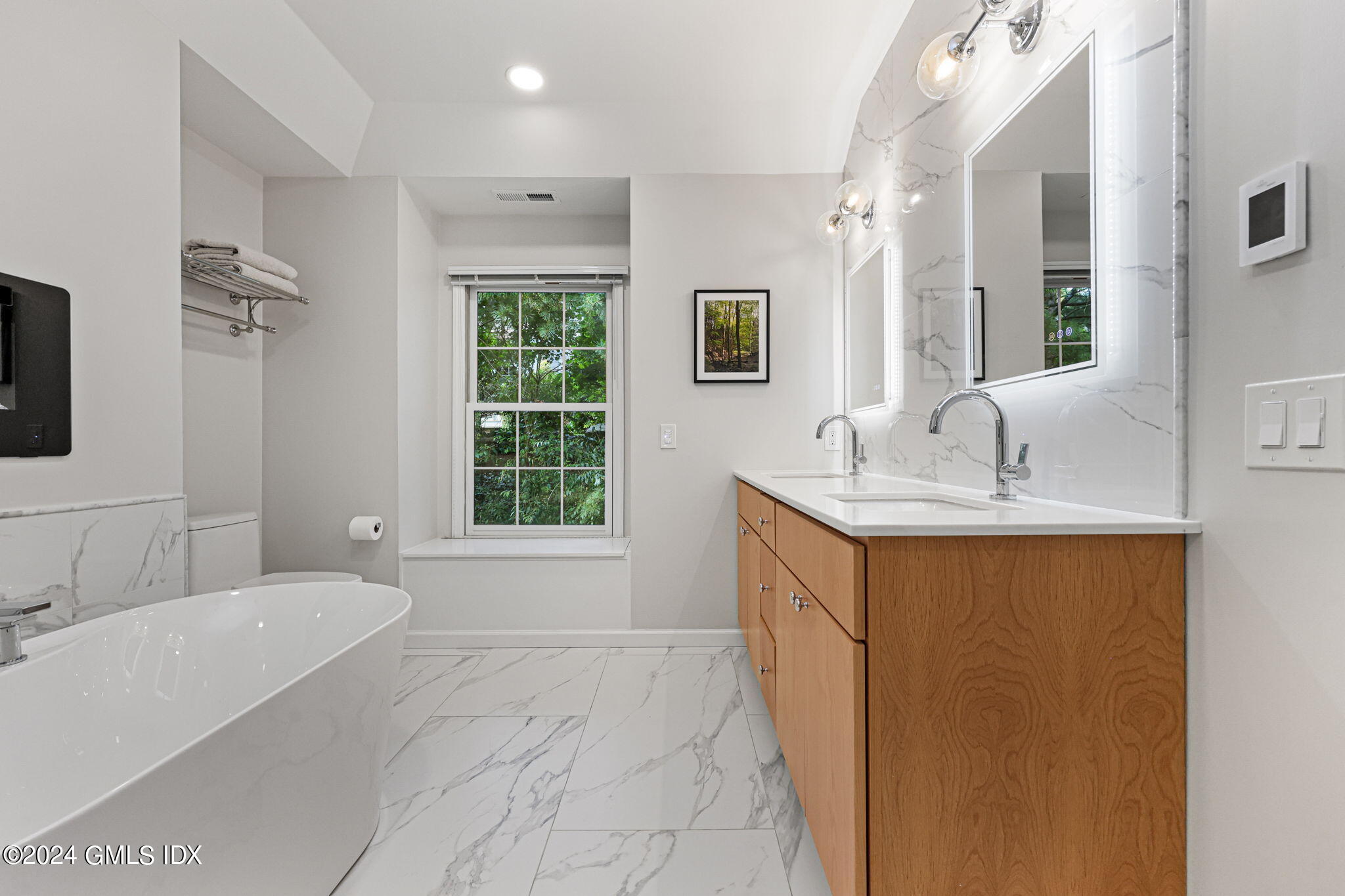 48 Spring Street, Unit 8 Greenwich, CT 06830 - Photo 19 of 24 a bathroom with a tub sink and mirror