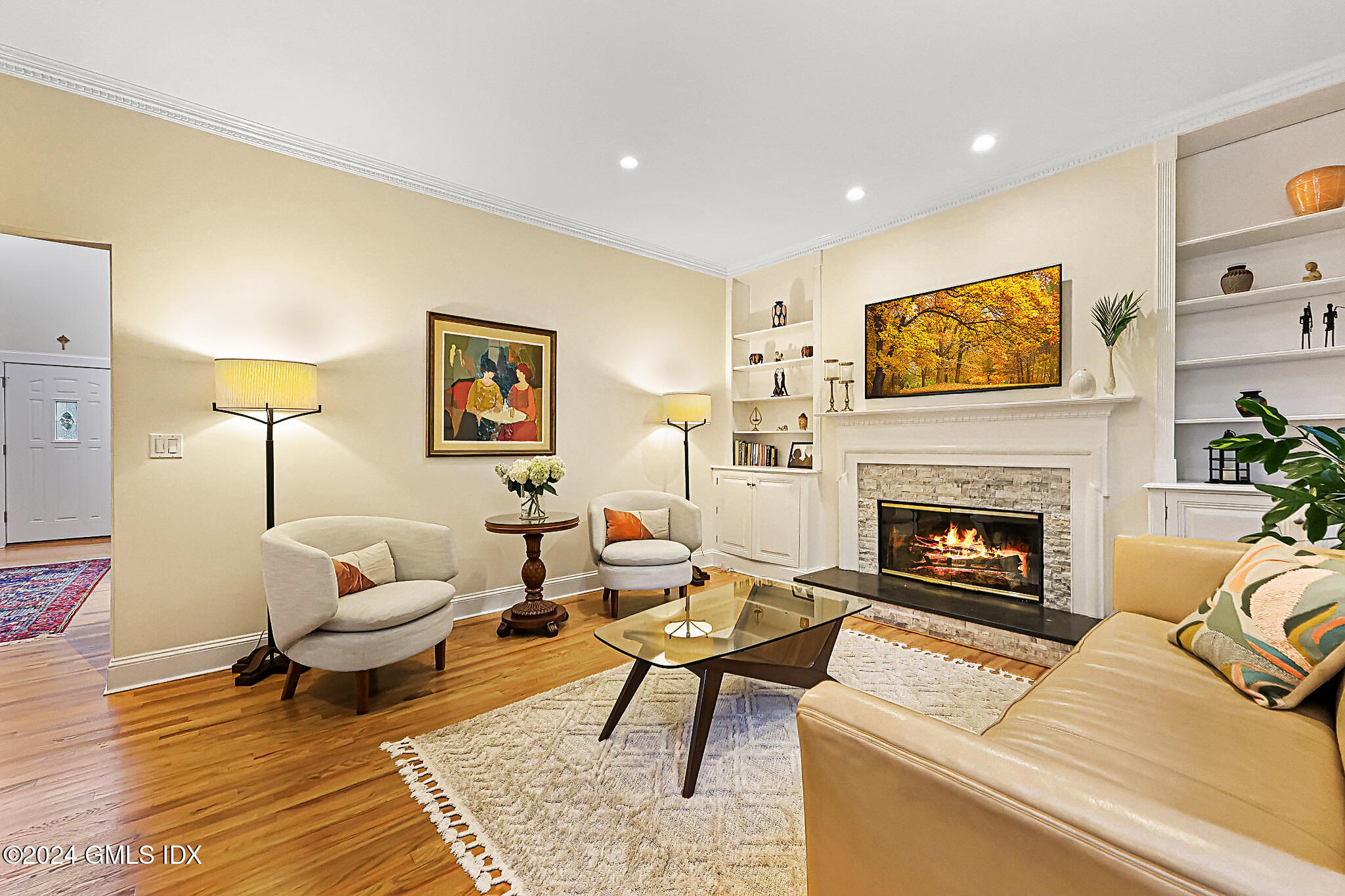 48 Spring Street, Unit 8 Greenwich, CT 06830 - Photo 3 of 24 a living room with furniture a fireplace and a potted plant