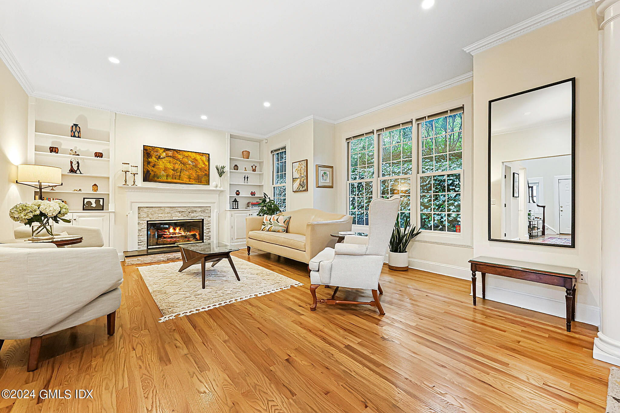 48 Spring Street, Unit 8 Greenwich, CT 06830 - Photo 4 of 24 a living room with furniture a fireplace and a flat screen tv