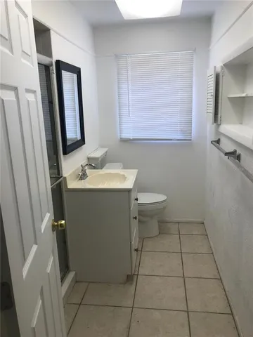 a bathroom with a glass shower door