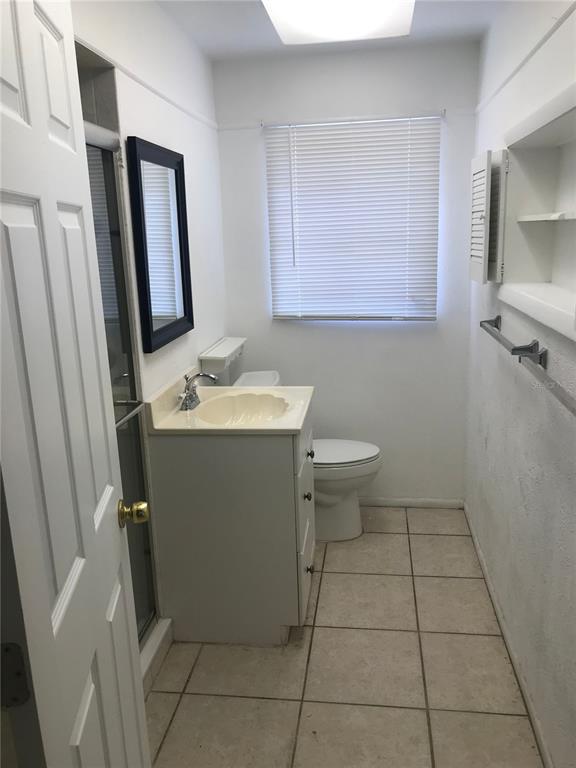 3943 Freedom Avenue, Unit 2 Sarasota, FL 34231 - Photo 12 of 15 a bathroom with a sink a toilet and a mirror