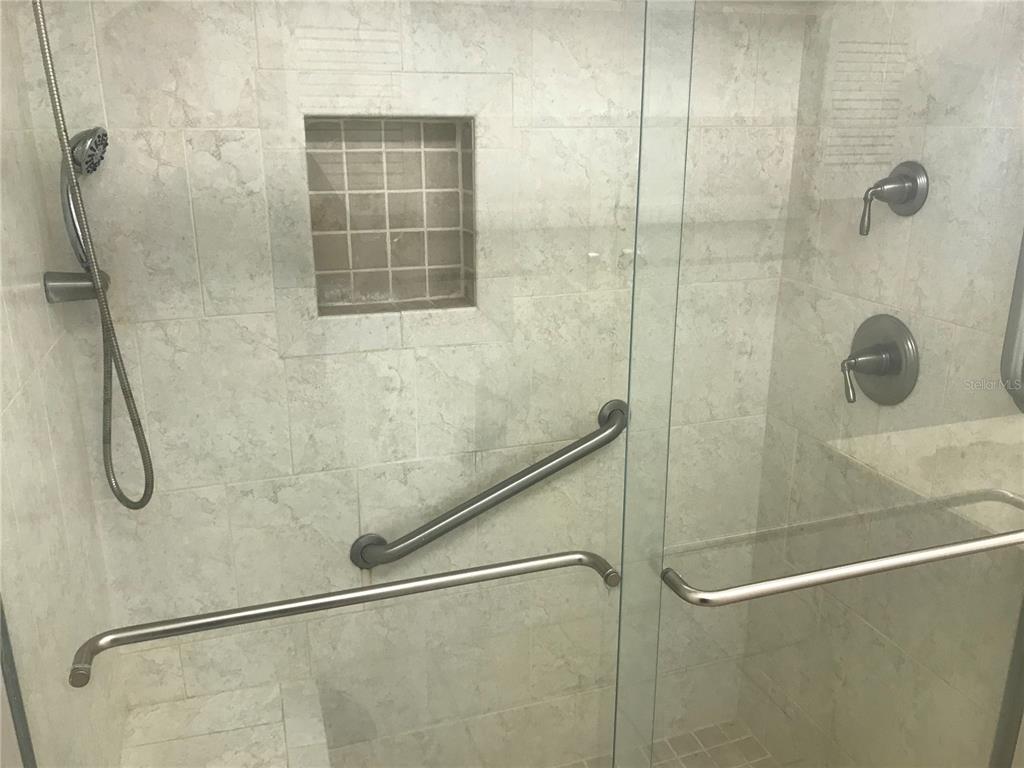 3943 Freedom Avenue, Unit 2 Sarasota, FL 34231 - Photo 14 of 15 a bathroom with a glass shower door