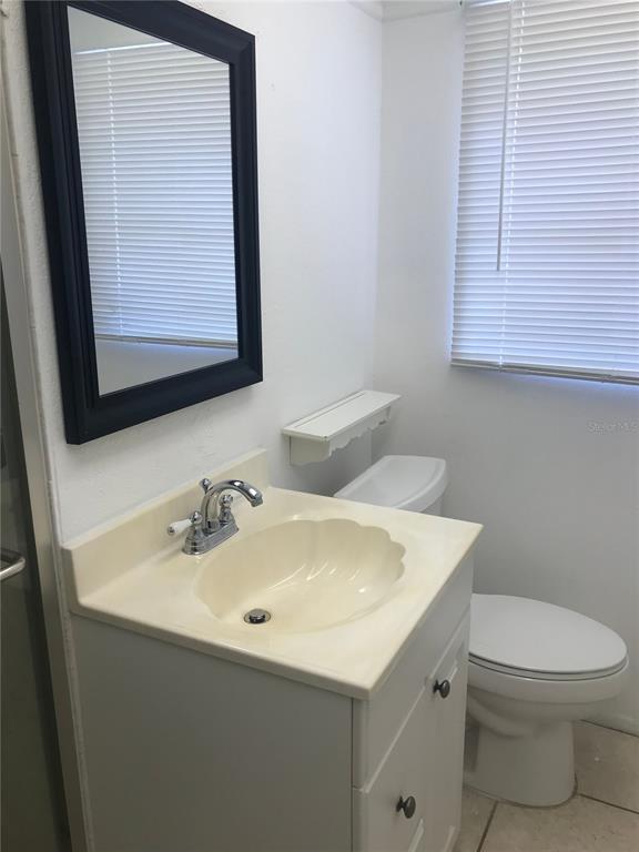 3943 Freedom Avenue, Unit 2 Sarasota, FL 34231 - Photo 15 of 15 a bathroom with a toilet sink and mirror