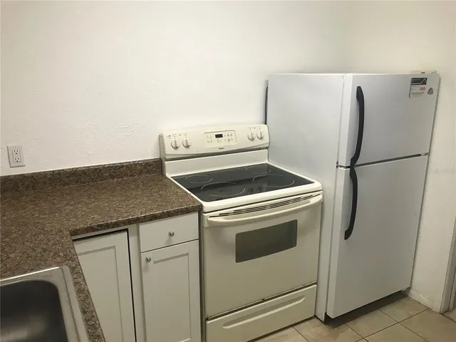 an empty room with fan and entrance