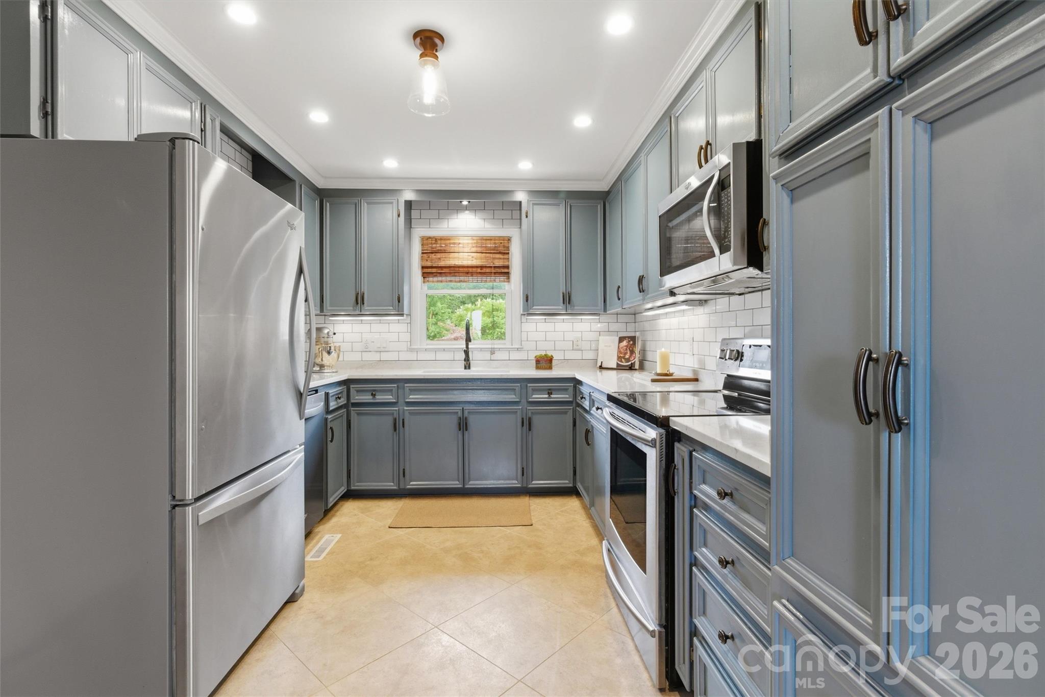 4712 Secrest Short Cut Road Monroe, NC 28110 - Photo 6 of 30 a kitchen with stainless steel appliances granite countertop a refrigerator a stove a sink and a refrigerator