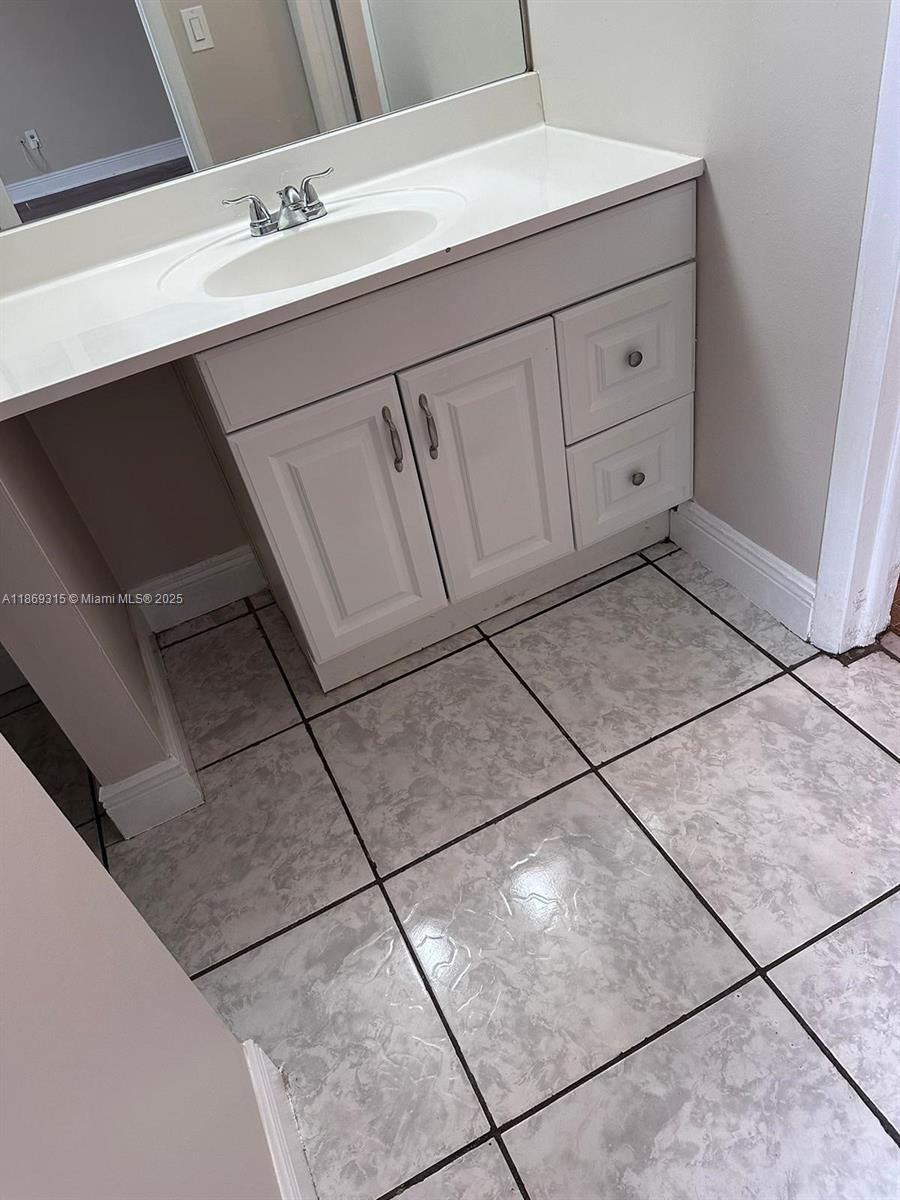 3390 Foxcroft Road, Unit C212 Miramar, FL 33025 - Photo 11 of 16 a bathroom with a sink and vanity