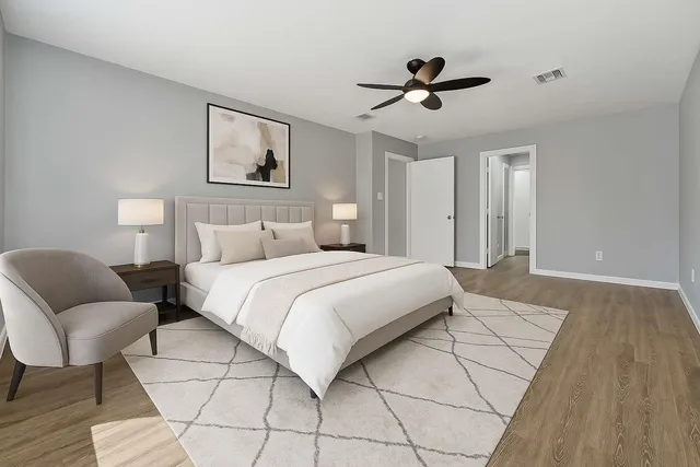 a bedroom with a bed and a chair