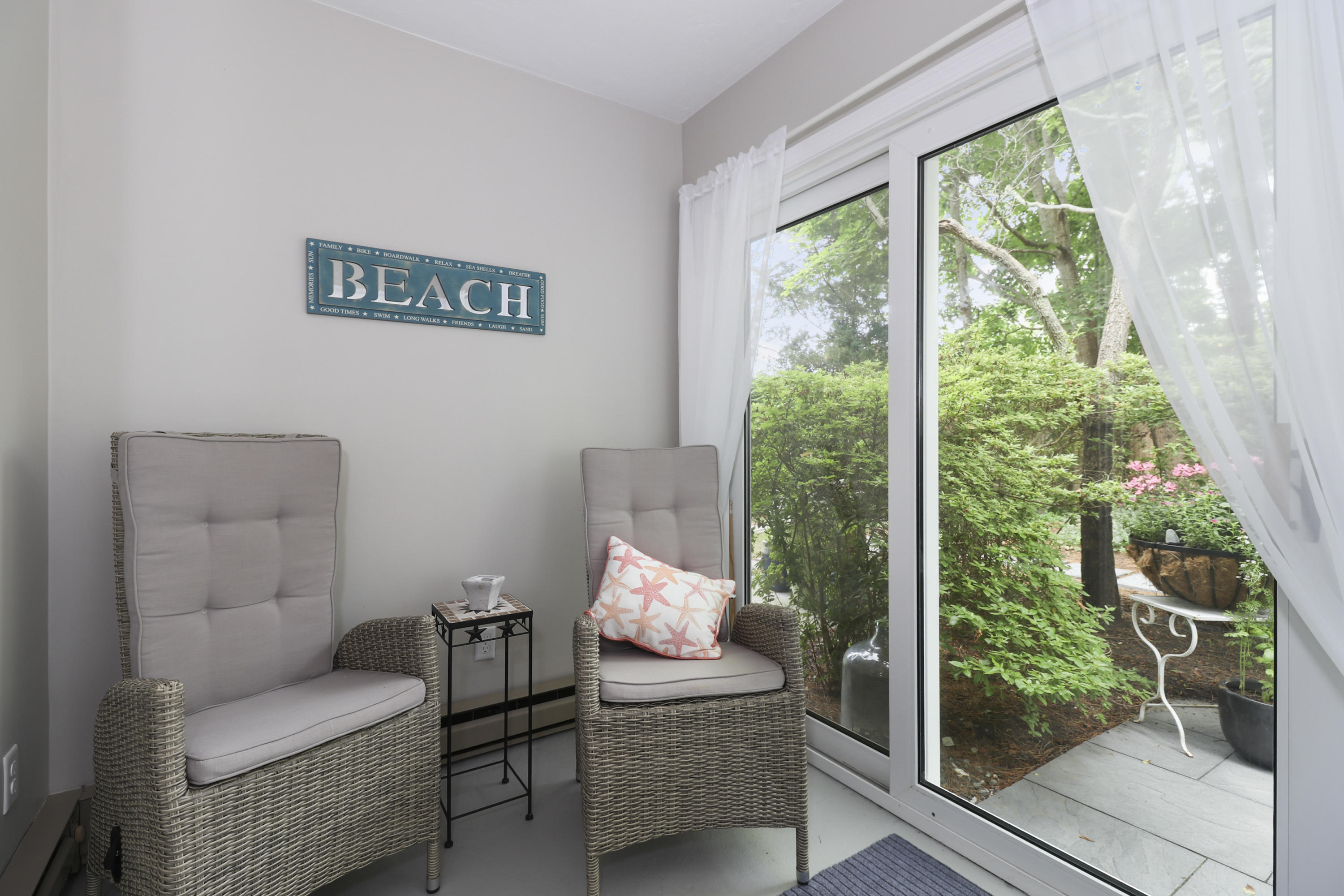 727 Main Street, Unit E1 Osterville, MA 02655 - Photo 12 of 20 a living room with furniture and a floor to ceiling window