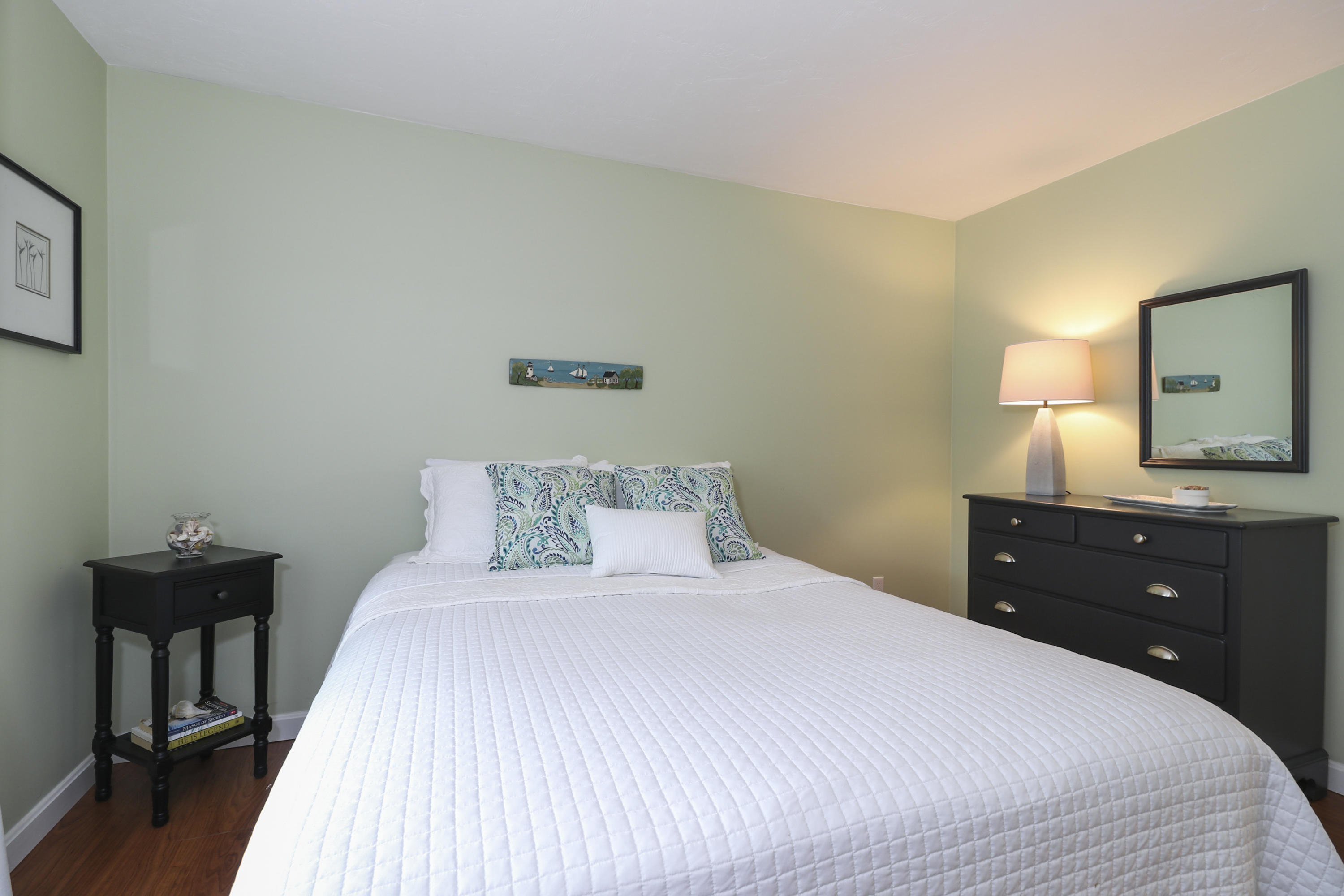 727 Main Street, Unit E1 Osterville, MA 02655 - Photo 17 of 20 a bedroom with a bed and a dresser