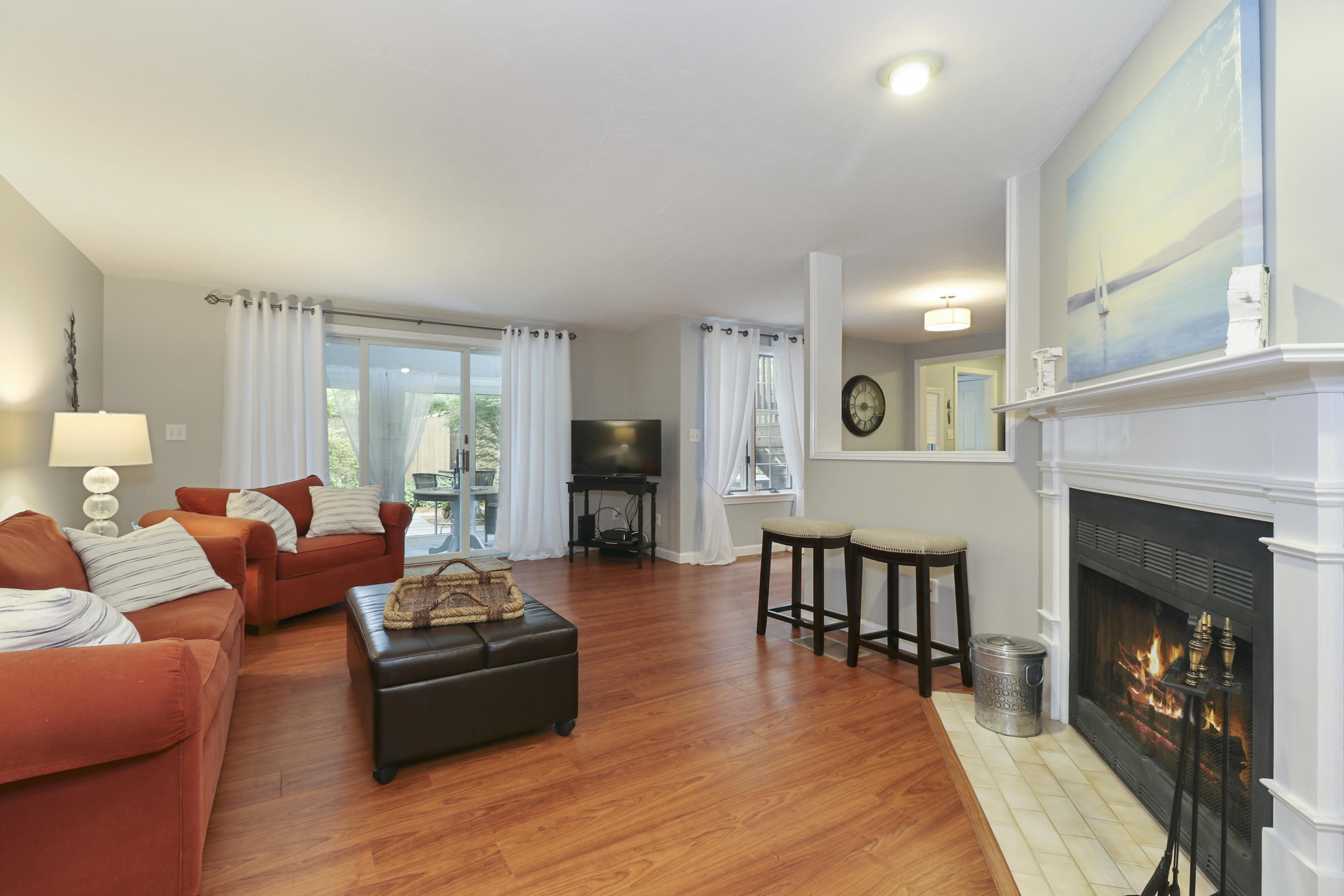 727 Main Street, Unit E1 Osterville, MA 02655 - Photo 2 of 20 a living room with furniture and a fireplace