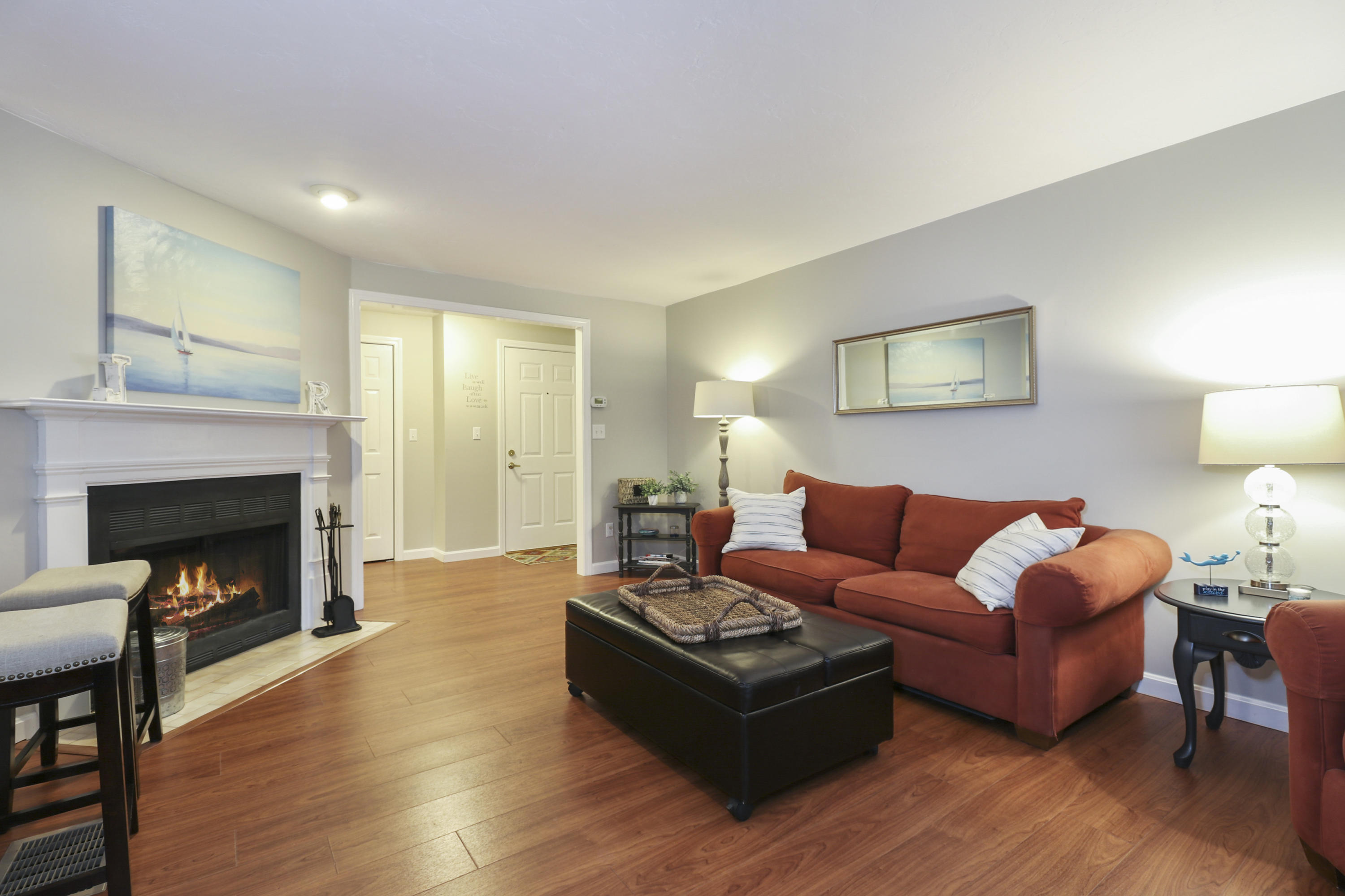 727 Main Street, Unit E1 Osterville, MA 02655 - Photo 3 of 20 a living room with furniture and a fireplace