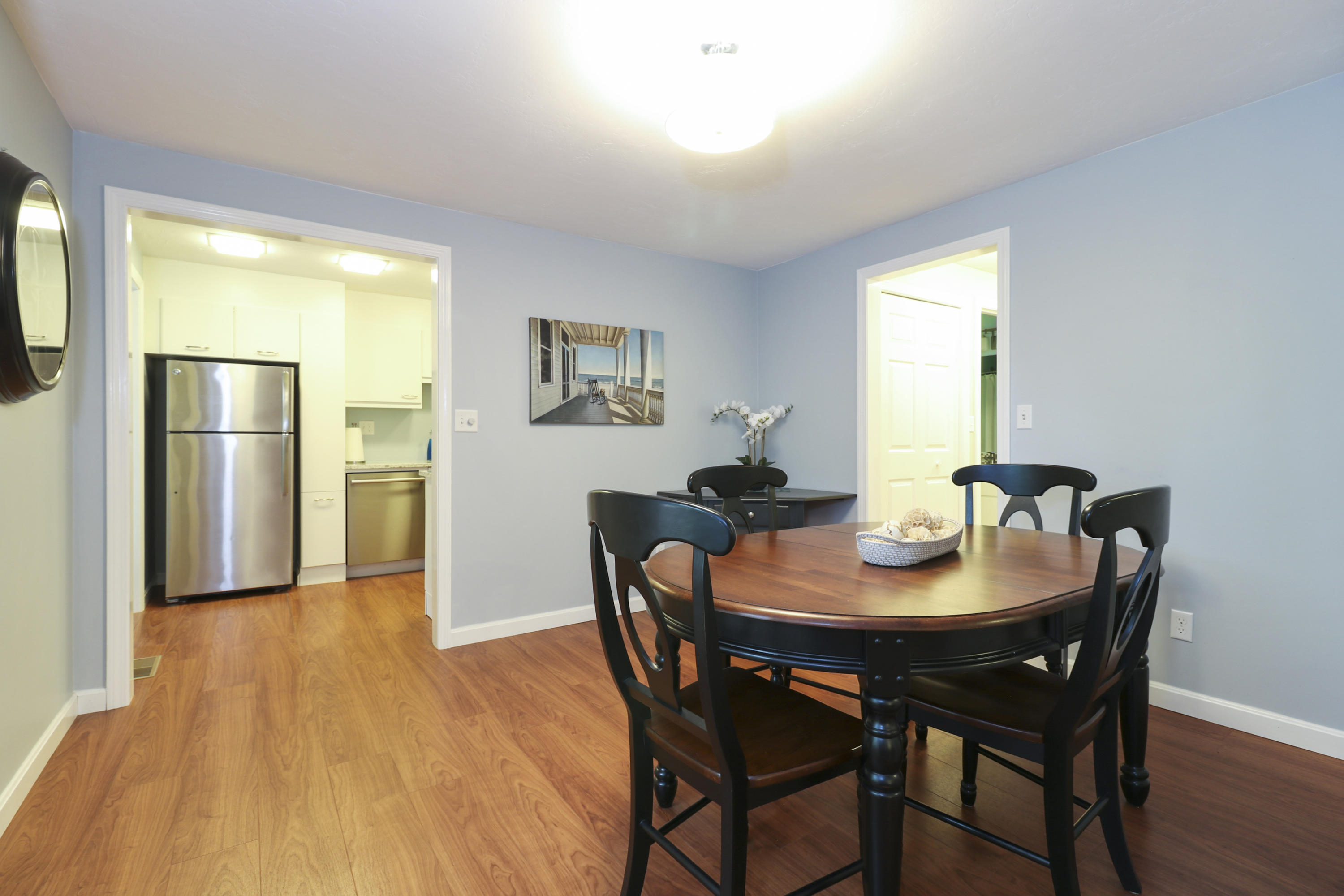 727 Main Street, Unit E1 Osterville, MA 02655 - Photo 8 of 20 a view of a dining room with furniture and wooden floor