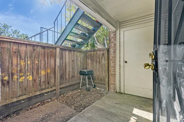 a view of an outdoor space with wooden floor and a bench