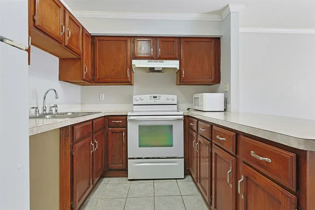 a kitchen with sink cabinets and stove