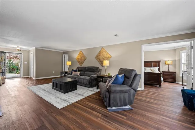 a living room with furniture or couch and a wooden floor