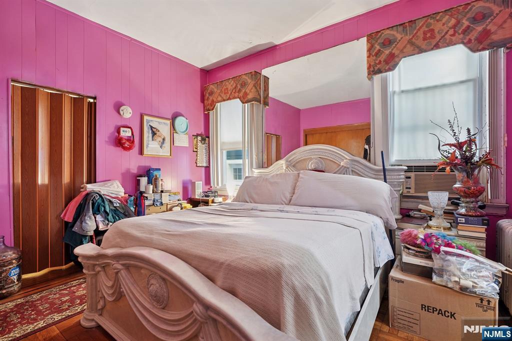 75 Coolidge Street Irvington, NJ 07111 - Photo 12 of 30 a bedroom with a bed and a mirror