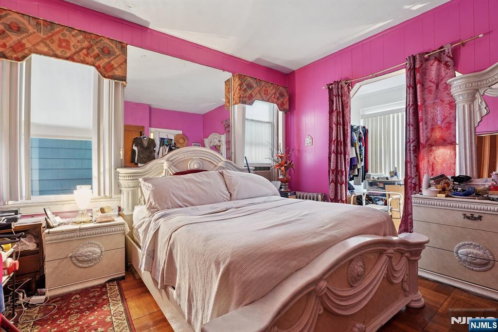 75 Coolidge Street Irvington, NJ 07111 - Photo 13 of 30 a bedroom with a bed next to a window and a mirror