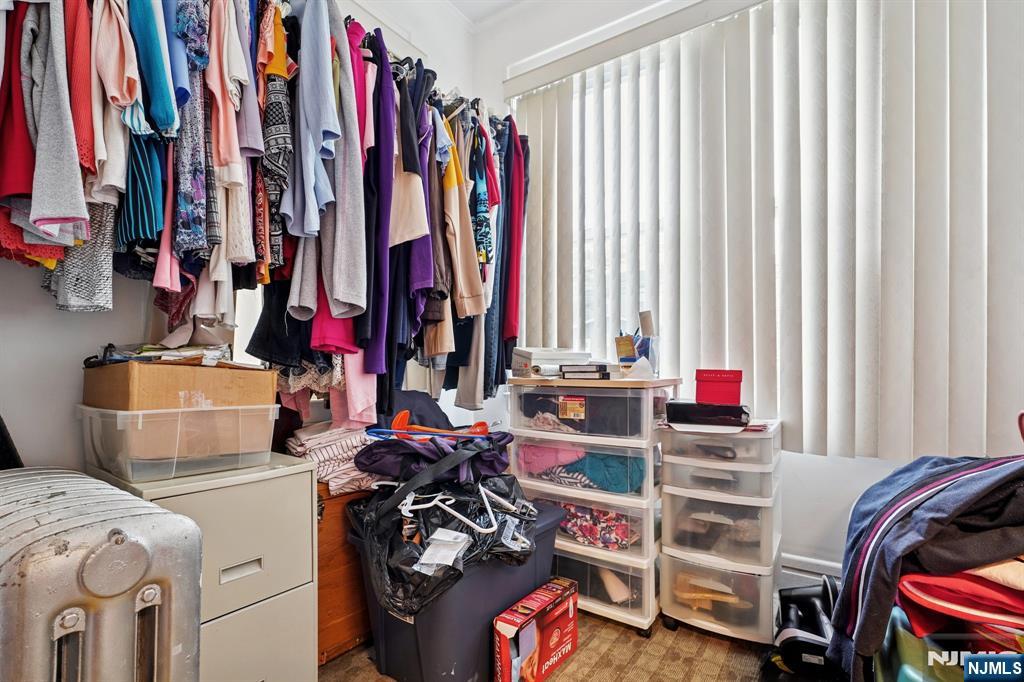 75 Coolidge Street Irvington, NJ 07111 - Photo 15 of 30 a view of walk in closet with clothes and shoes