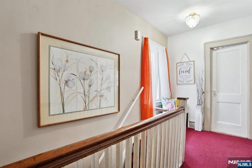 75 Coolidge Street Irvington, NJ 07111 - Photo 17 of 30 a view of a hallway with paintings on the wall