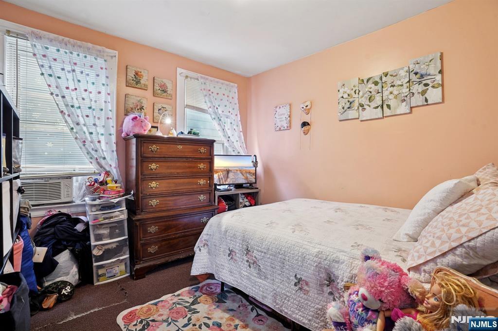 75 Coolidge Street Irvington, NJ 07111 - Photo 20 of 30 a bedroom with a bed and a baby crib