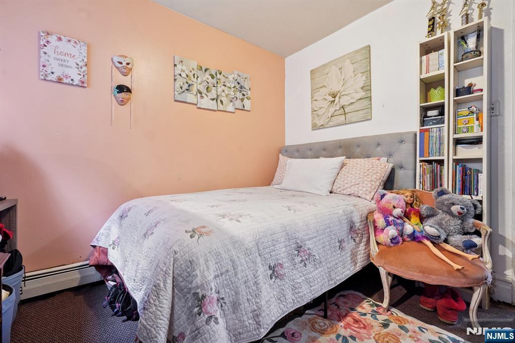 75 Coolidge Street Irvington, NJ 07111 - Photo 21 of 30 a bedroom with a bed and a window