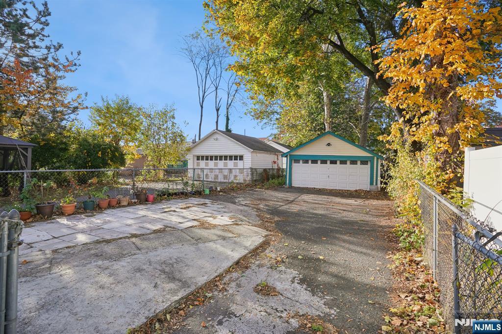 75 Coolidge Street Irvington, NJ 07111 - Photo 28 of 30 a view of sign board with yard and trees in the background