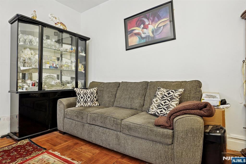 75 Coolidge Street Irvington, NJ 07111 - Photo 5 of 30 a living room with furniture and a floor to ceiling window
