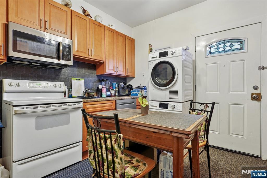 75 Coolidge Street Irvington, NJ 07111 - Photo 10 of 30 a kitchen with stainless steel appliances granite countertop a kitchen island a stove a table and chairs