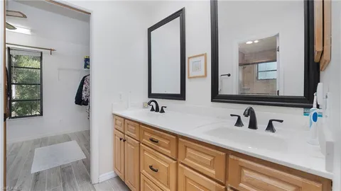a bathroom with a double vanity sink and mirror