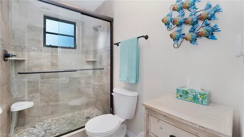 a white toilet sitting next to a bathroom sink