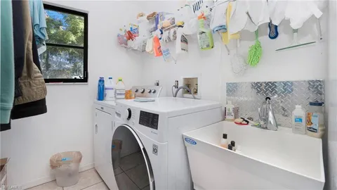 a utility room with multiple dryer and washer