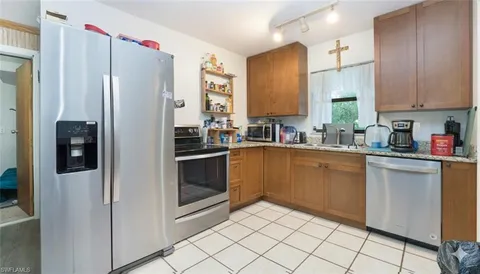 a kitchen with a sink cabinets and stainless steel appliances