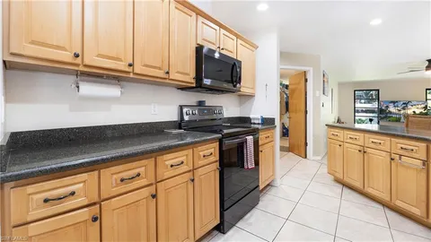 a kitchen with stainless steel appliances granite countertop a sink and a stove