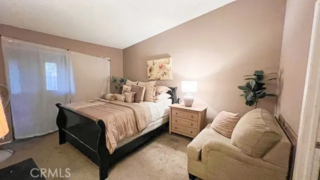 a bedroom with a bed and a couch