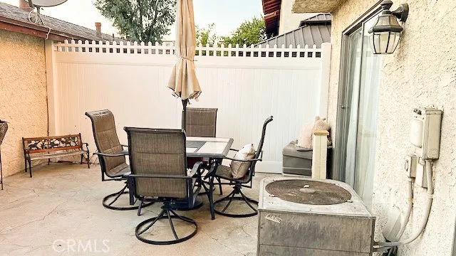 a table and chairs in front of a house