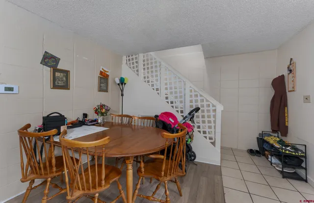a view of a dining room with furniture and chandelier