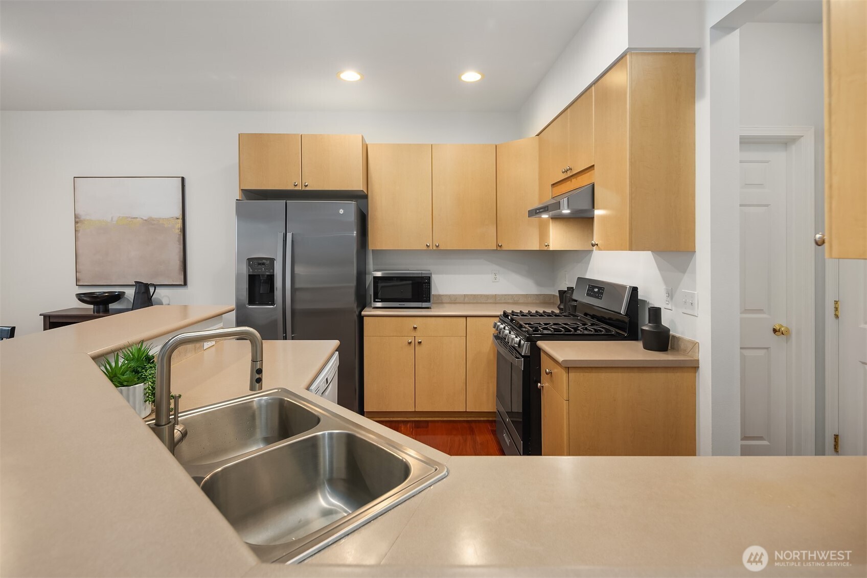 325 South 51st Street, Unit A Renton, WA 98055 - Photo 14 of 39 a kitchen with stainless steel appliances granite countertop a sink a stove and a refrigerator