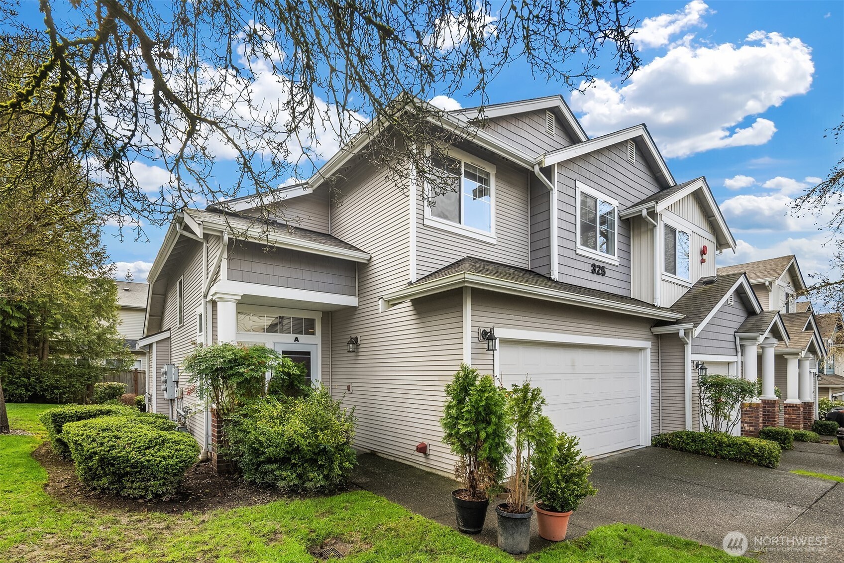 325 South 51st Street, Unit A Renton, WA 98055 - Photo 2 of 39 a front view of a house with a garden and plants