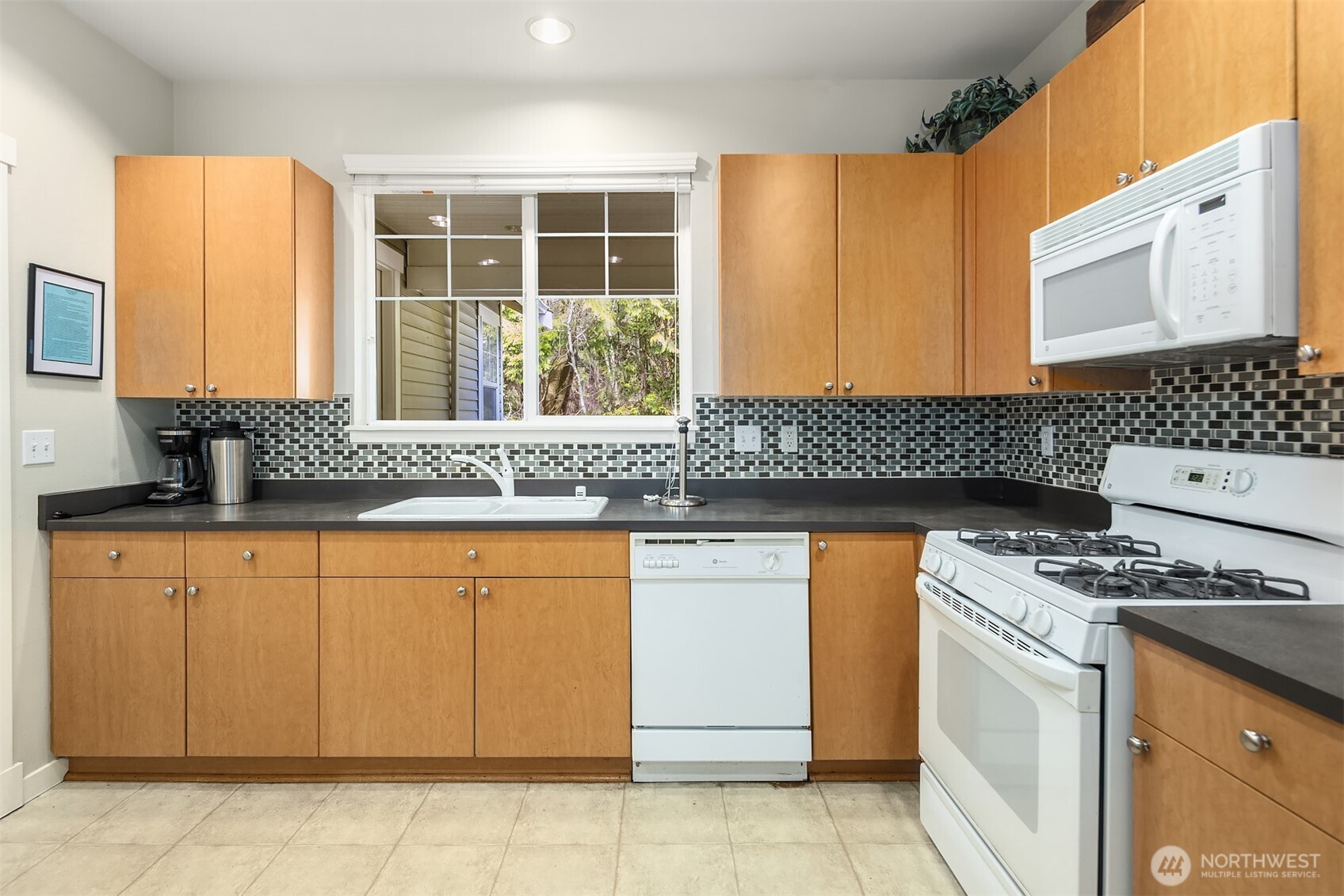 325 South 51st Street, Unit A Renton, WA 98055 - Photo 35 of 39 a kitchen with granite countertop cabinets and white appliances