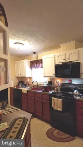 a view of a livingroom with workspace and a couch