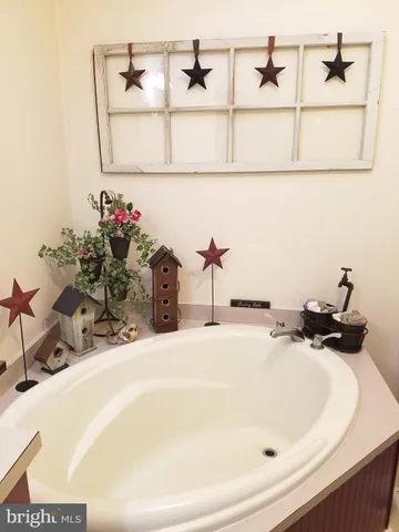 a view of a white house next to a yard