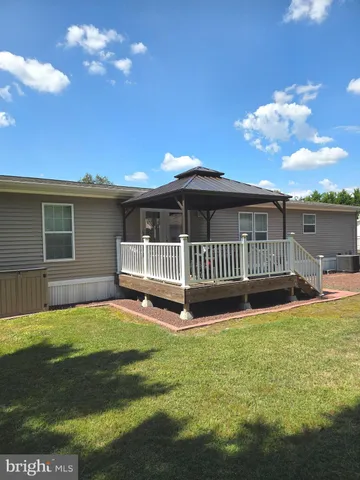 a view of a house with a swimming pool and deck