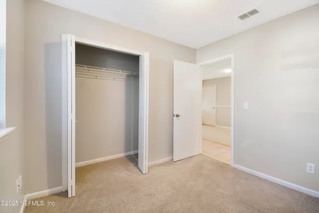 an empty room with a fan and a fan