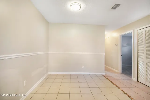 a view of an empty room and closet area