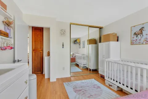 a bedroom with a large bed and a flat screen tv