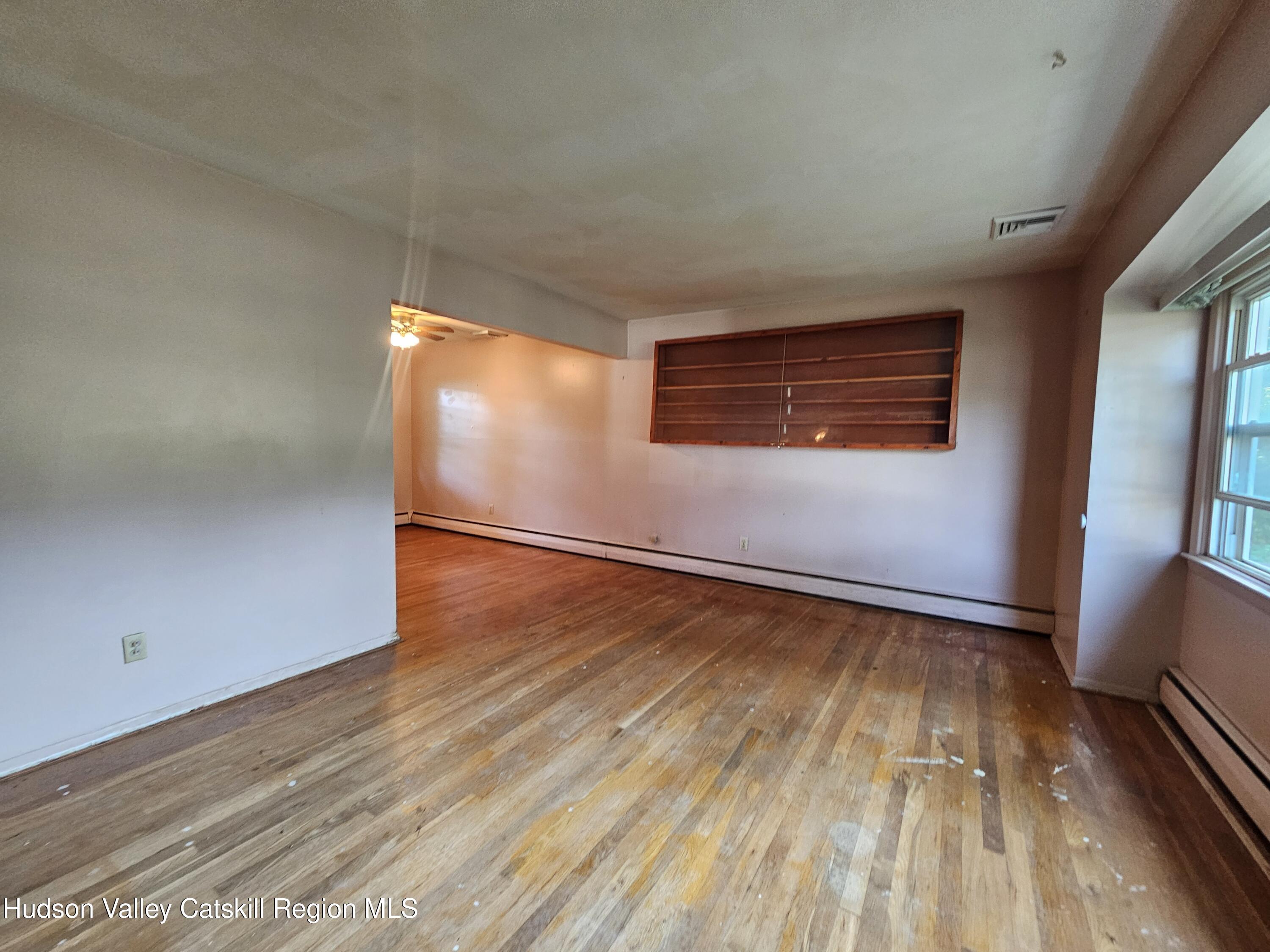 10 Amherst Road Red Hook, NY 12571 - Photo 3 of 20 an empty room with wooden floor and windows