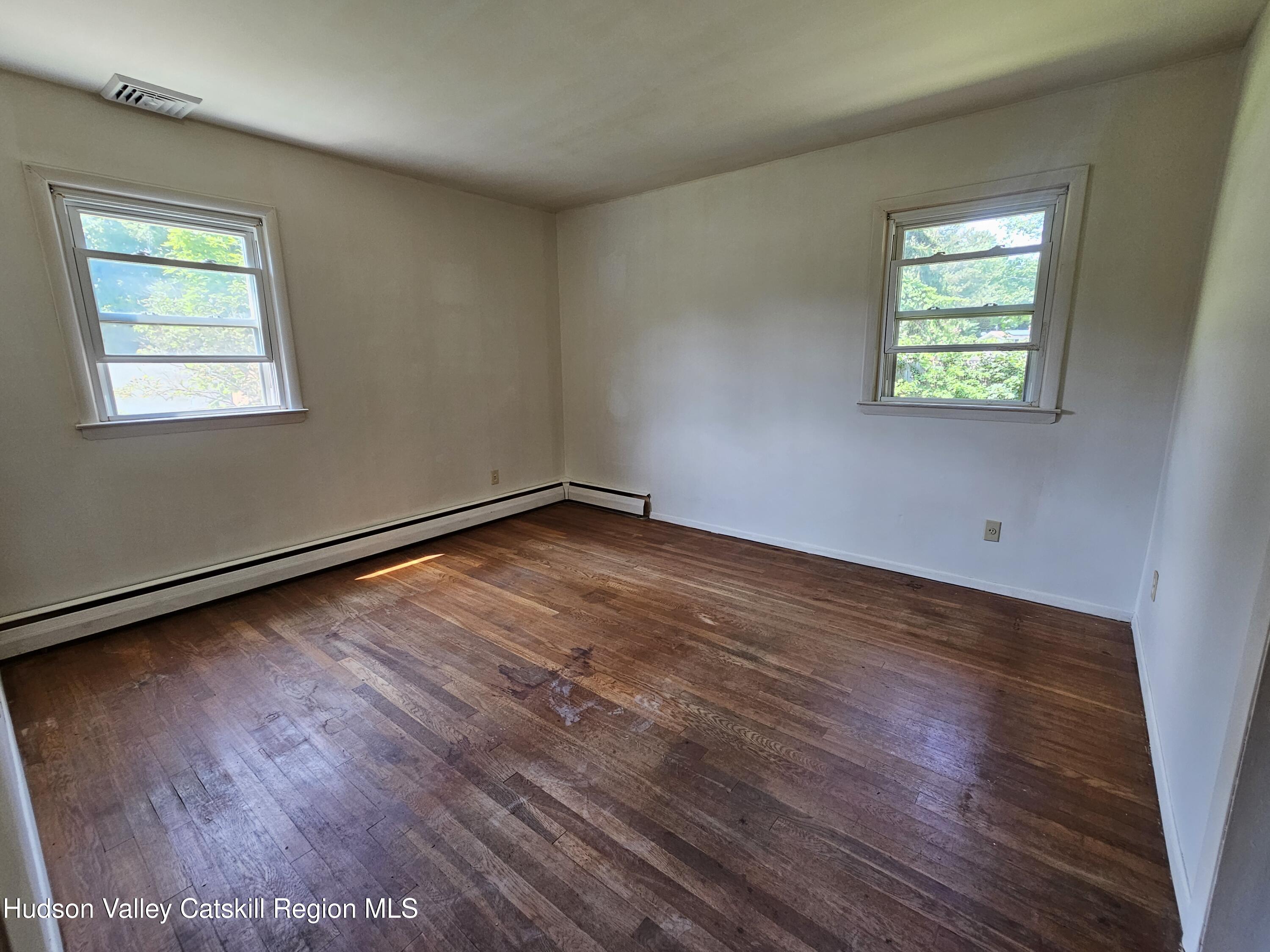 10 Amherst Road Red Hook, NY 12571 - Photo 6 of 20 a view of an empty room with wooden floor and a window