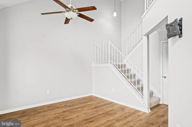 a view of a hallway with wooden floor and entryway