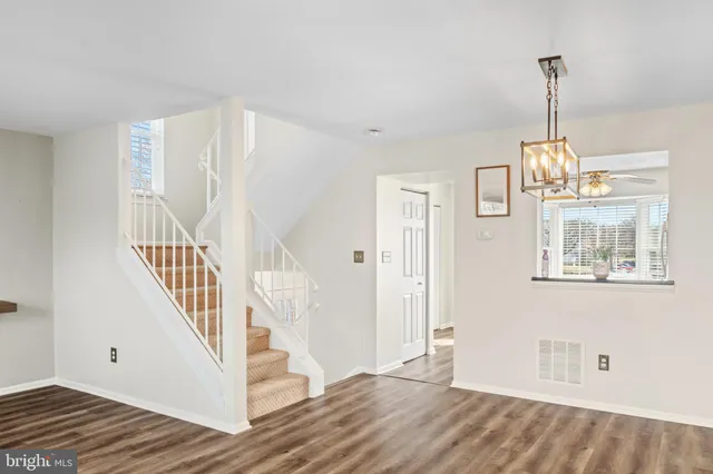 a view of an entryway with wooden floor